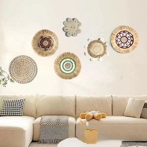 Detailed close-up of bohemian woven straw wall decor featuring unique geometric patterns