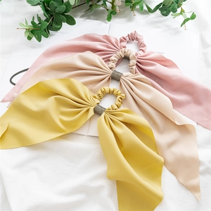 Set of 3 satin bow scrunchies in pink, apricot, and yellow with rhinestone details