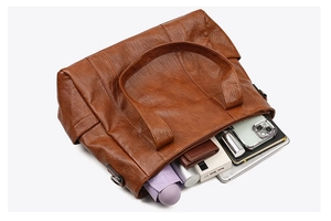Top view of large brown leather tote bag showing organized interior storage capacity