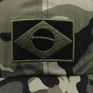 Close-up of tactical Brazil flag embroidery on rugged camouflage canvas baseball hat