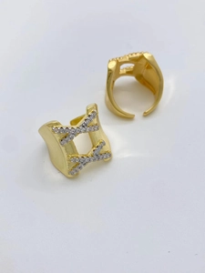 Close-up of gold-plated open ring featuring wide hollow design and micro-paved zircons