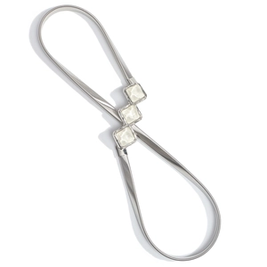 Macro view of silver elastic metal spring belt with square white gemstone buckle