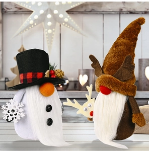Detail of Christmas plush gnomes with top hat and reindeer antlers in a festive setting