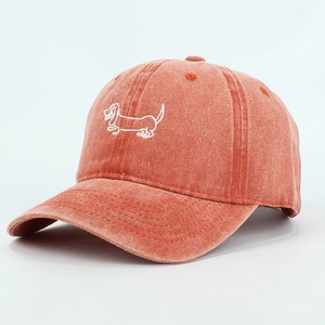 Detail of dachshund embroidery on terracotta washed cotton vintage baseball cap