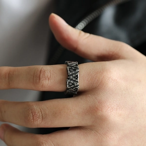 Detailed view of vintage oxidized titanium steel ring with 3D geometric triangular relief