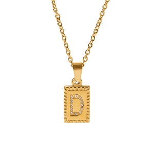 Detail view of a gold pendant necklace featuring a sparkling letter D cubic zirconia inlay