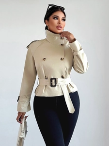 Detailed view of khaki double-breasted short trench coat with matching belt and lapel