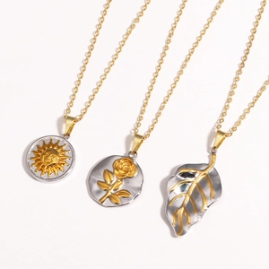 Detailed shot of titanium steel necklaces featuring sun, rose, and leaf charms in gold