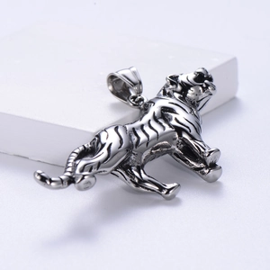 Detailed view of a running tiger pendant in silver stainless steel on a white stone base