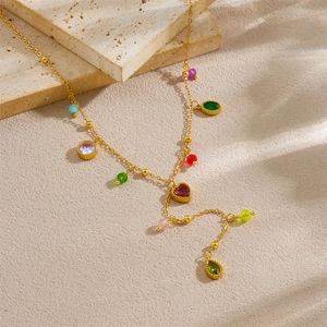 Gold stainless steel Y-necklace with multi-colored glass pendants on marble background