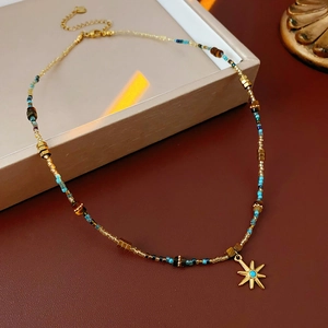 Detail of sun pendant necklace with blue gem and colorful beads on leather display