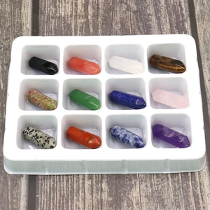 Detail view of 12 pieces natural crystal hexagonal prisms in a white display tray