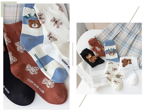 Close-up of teddy bear embroidery and preppy style patterns on soft cotton crew socks