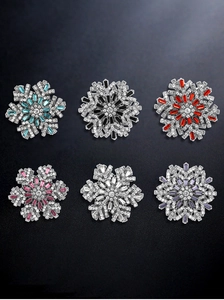 Detailed display of six colorful snowflake brooches with sparkling crystal rhinestones