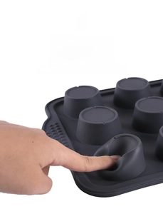 Close-up of flexible grey silicone muffin mold showing high resilience and soft texture