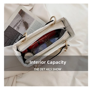 Macro view showing the internal capacity of a white quilted bridal handbag with items