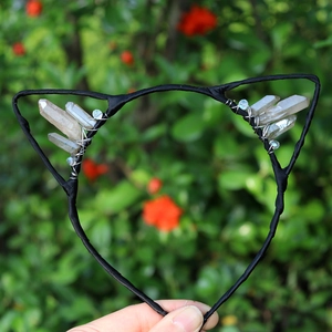 Detail of a black cat ear headband with crystal clusters and blue bead wire wrapping