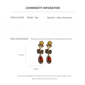 Detailed size specifications for vintage oval earrings with amber gems and rhinestones
