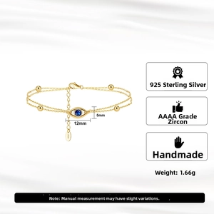 Macro view of 925 sterling silver evil eye bracelet with blue zircon and gold plating