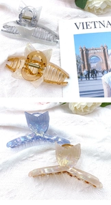 Detailed view of iridescent frosted fishtail hair claws with elegant acrylic texture