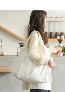 Macro detail of white pleated Dupont paper tote bag with large capacity texture