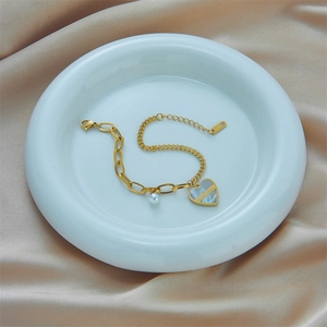 Elegant gold titanium steel chain bracelet with pearl and lucky heart pendant on silk
