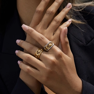 Detail of 18K gold-plated stainless steel ring featuring celestial moon and star cutouts