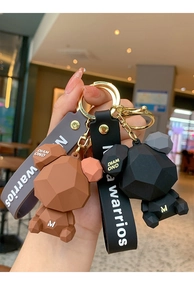 Detail of geometric bear keychains in brown and black with matte silicone texture