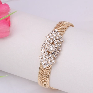 Detailed macro shot of vintage gold evil eye bracelet with white crystal rhinestones