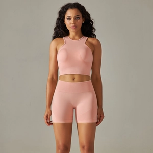 Detail of pink seamless ribbed sports bra and high-waist shorts fitness set