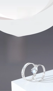 Detailed view of noctilucent S925 silver couple rings with glowing moonstone finish