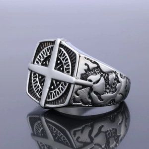 Silver stainless steel punk compass ring with intricate embossed patterns on the band