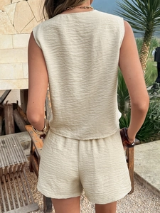 Rear view of beige sleeveless top and shorts set with pleated texture for summer vacation
