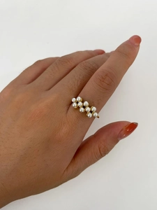 Detailed view of 18k gold plated ring with elegant double row of pearls on finger