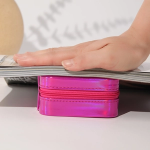 Pressure test of pink portable jewelry box showing strong structural resistance