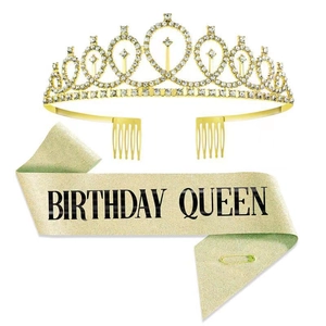 Detail of a gold rhinestone birthday crown and gold glitter sash with BIRTHDAY QUEEN text