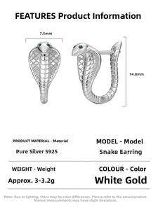 Macro detail of S925 sterling silver cobra earrings with green gemstone snake eyes