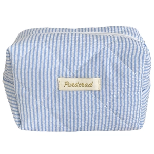 Blue and white candy stripe quilted vanity bag with heart stitching and gold brand logo