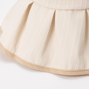 Women's pleated sun hat with wide brim and contrast piping in cream and beige colors