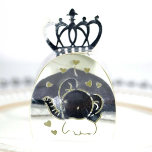 Detail of silver laser-cut elephant and crown candy box for festive gift packaging