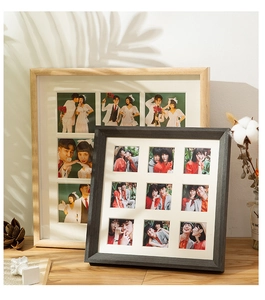 Close-up of wood grain multi-photo frames with white matting in a home setting
