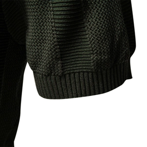 Close-up of deep green knit polo shirt sleeve with waffle texture and ribbed cuff