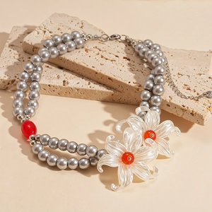 Double-layer gray faux pearl necklace with large white floral charms and red bead accents