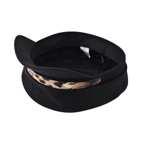 Detail of black newsboy hat featuring leopard print chain and interior lining labels