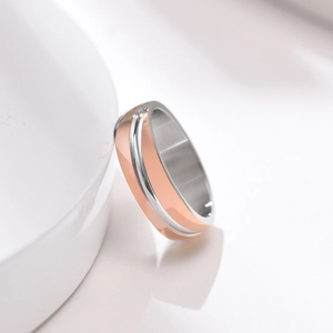 Macro detail of men's titanium steel ring with rose gold and silver tone oblique texture