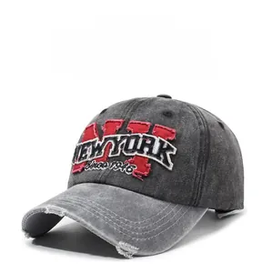 Close-up of vintage washed denim baseball cap with 3D New York embroidery and distressed brim