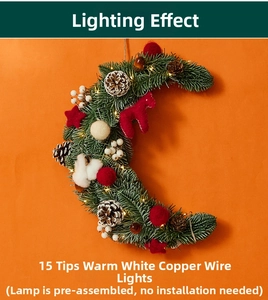 Close-up of moon-shaped Christmas wreath with LED lights, pine cones and red horse decor