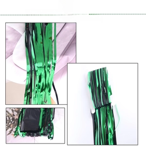 Detail of green and black metallic fringe curtain with high-gloss reflective texture
