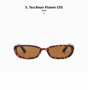 Detail view of small rectangular sunglasses with retro tortoise shell frame and amber lenses