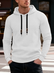 Close-up of white waffle texture fabric and black hood drawstrings on a men's hoodie